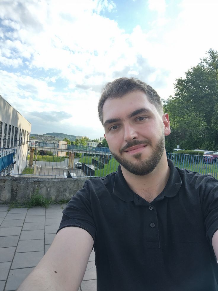 Unprofessional profile photo with a cluttered background