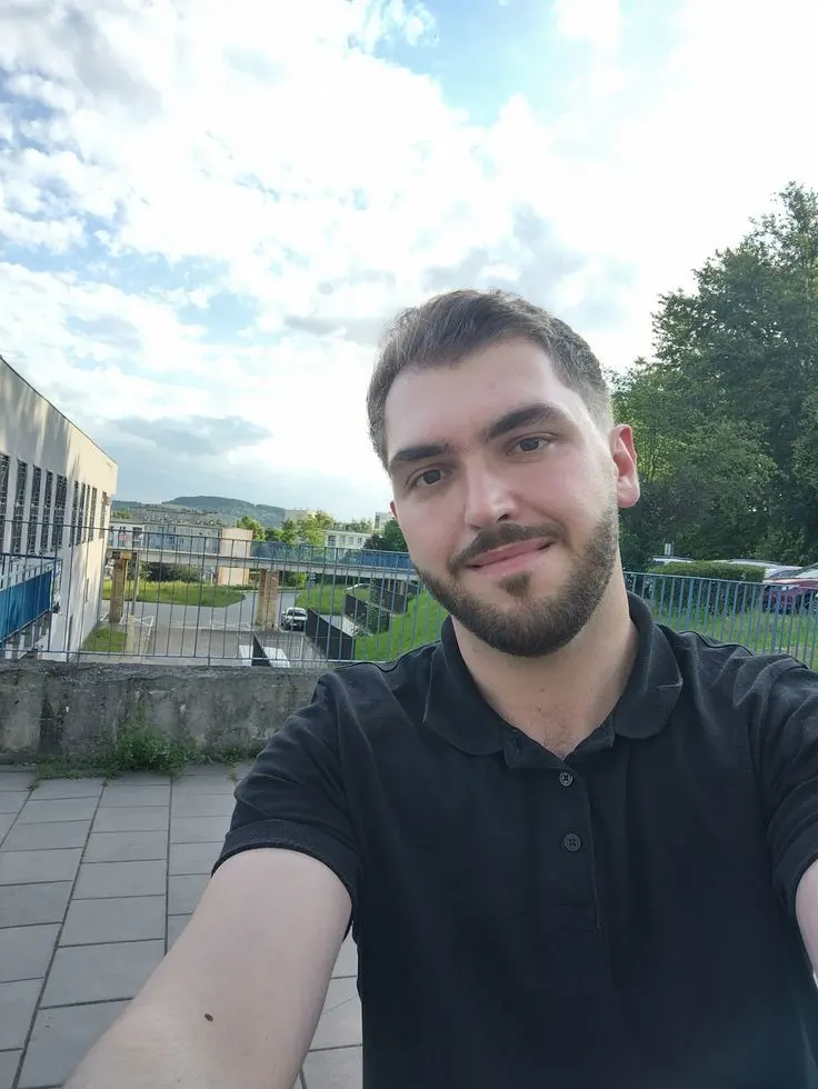 Unprofessional profile photo with a cluttered background